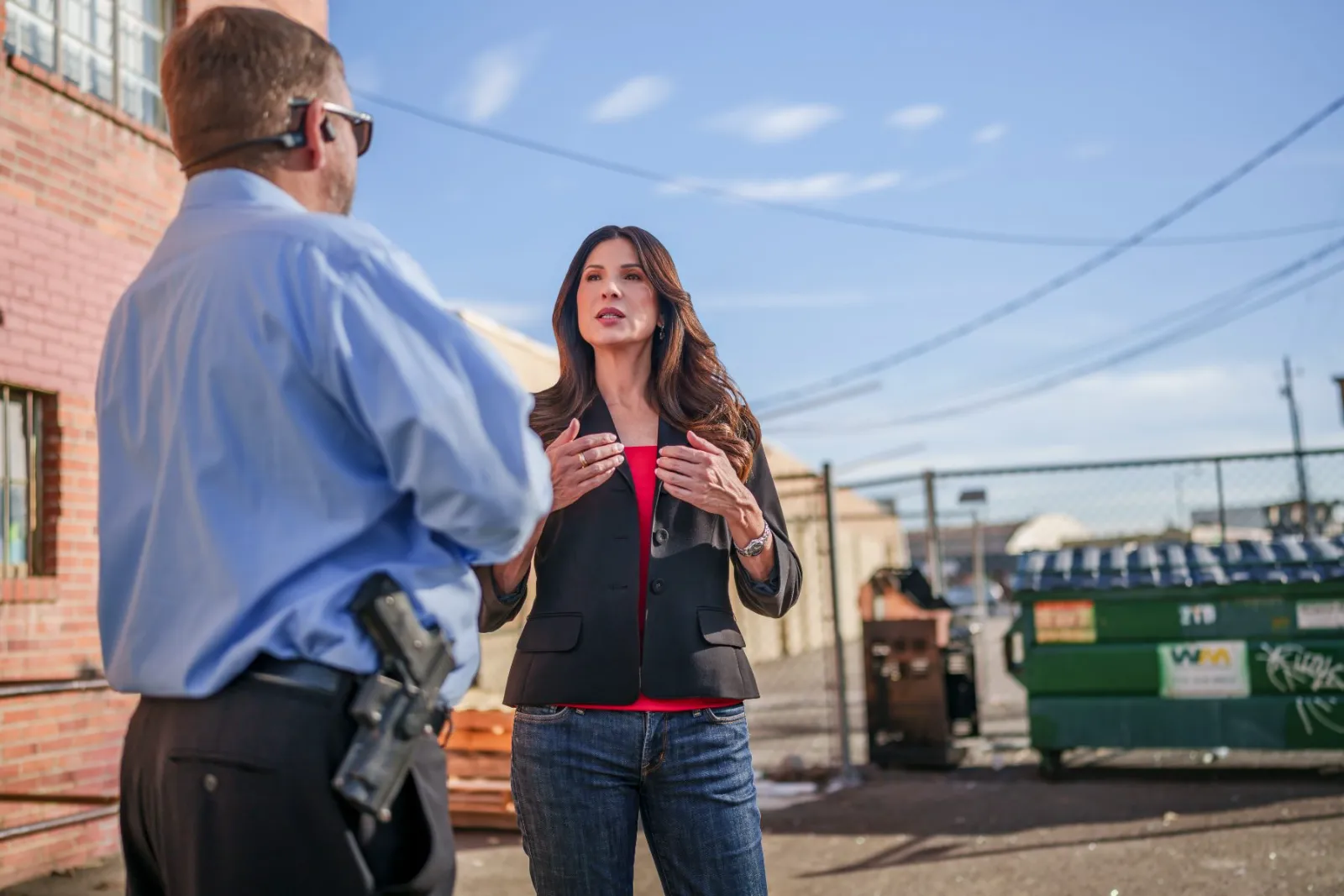 Adriana Guzmán Fralick talking with a law enforcement officer