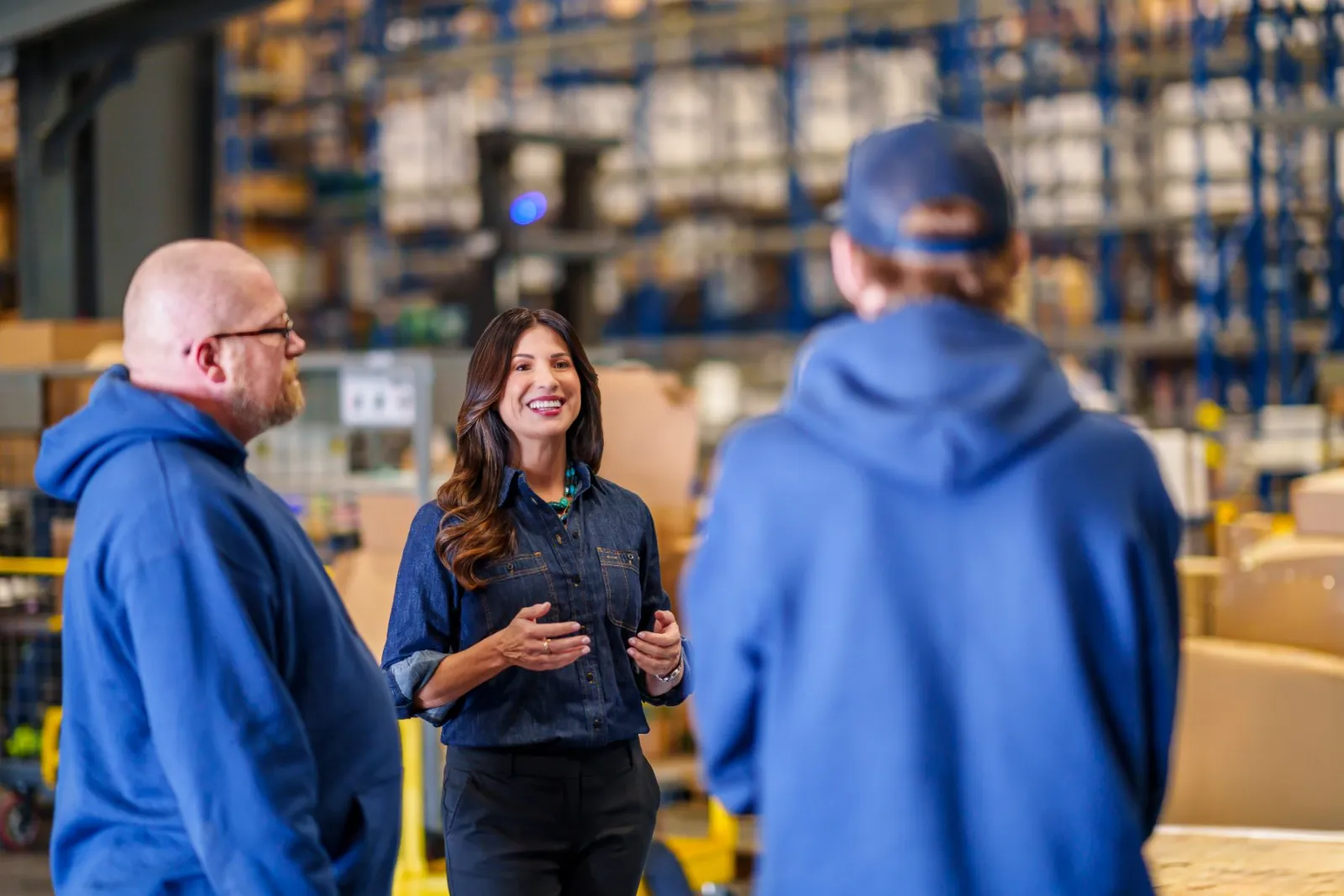 Adriana Guzmán Fralick talking with warehouse workers